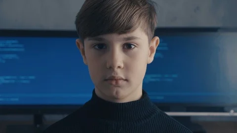 Prodigy Boy Hacker Programmer at data center filled with monitor screens Vidéo 102144701