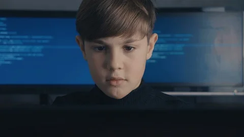 Prodigy Boy Hacker Programmer working on computer in secret data center Vidéo 102144041