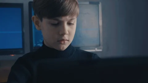 Prodigy Boy Hacker Programmer working on computer in secret data center Vidéo 102144327