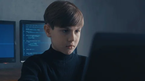 Prodigy Boy Hacker Programmer working on computer in secret data center Vidéo 102751316