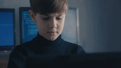 Prodigy Boy Hacker Programmer working on computer in secret data center Vidéo 102751785