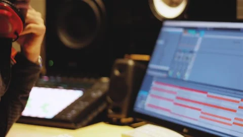 Producer working on music in front of computer Stockbeeldmateriaal 245752437