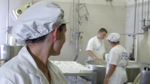 Producing cheese: worker inside typical italian dairy factory Stock Footage 42996293