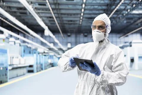 Producing integrated circuits, tablet and man in factory Stock Photos