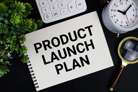 Product Launch Plan text written on notepad with alarm clock, magnifying gl.. Stock Photos