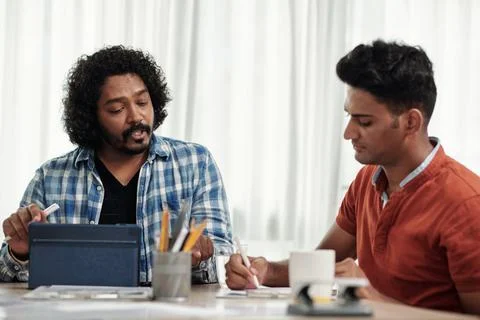 Product Manager and Developer Discussing Project Stock Photos