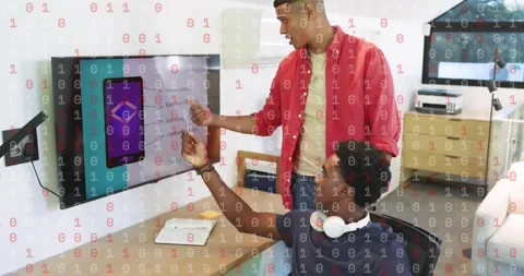Product manager entering office with documents and guiding seated developer in Stock Footage 318173605