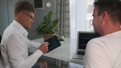 The product manager suggests improvements to the developer. Stock Footage 294298781