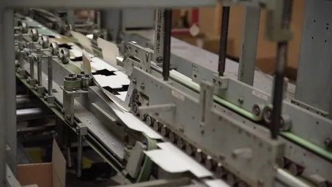 Product packaging being folded by machine on conveyor belt Stock Footage 78672210