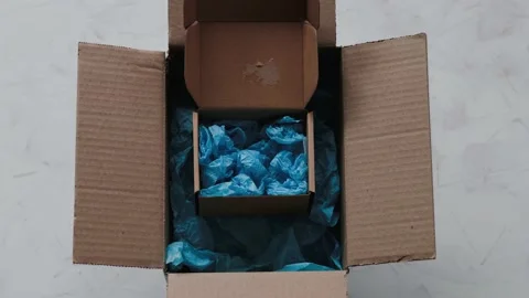 Product tag with small business text inside ofsmaller delivery parcel inside  Stock Footage 154792133