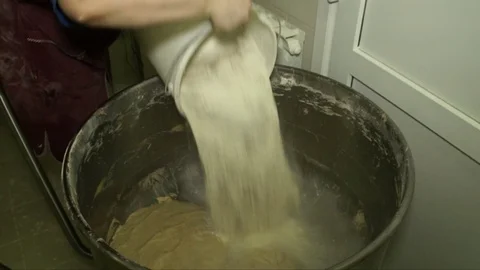 Production of bread. The machine for mixing add flour Video stock 71815813