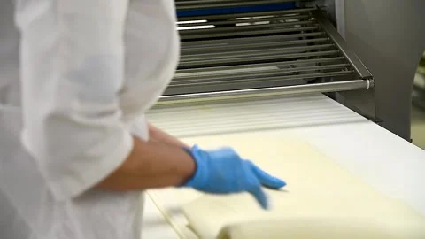 Production of buns, pies, bread, cookies in a bakery on an automated convey.. Stock Footage 252520063
