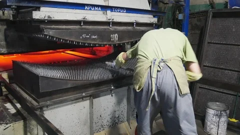 Production of car Windows.Working pulls from the oven is tempered glass. Stock-Footage 122216694