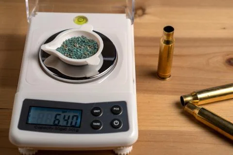 Production of cartridges for a rifle, reload. Empty shells and gunpowder scales Stock Photos