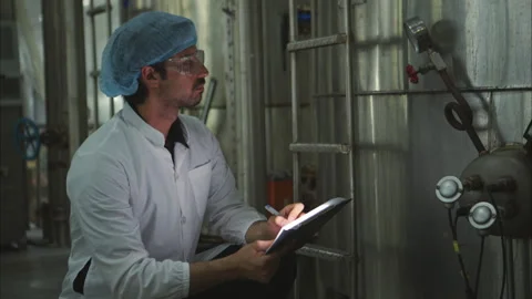 The production control supervisor inspects and controls the operation Stock Footage 308310388