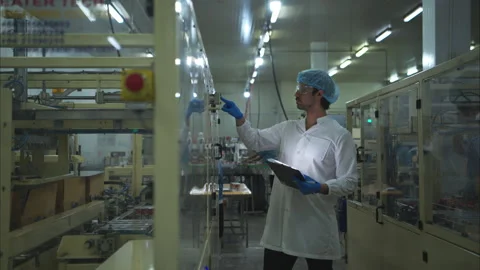 The production control supervisor inspects and controls the operation Stock Footage 308313327
