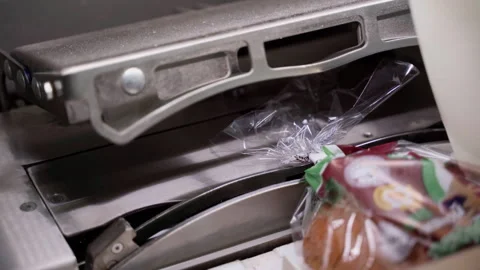 The production conveyor for slicing bread puts a seal on the packaging Stock Footage 250264646