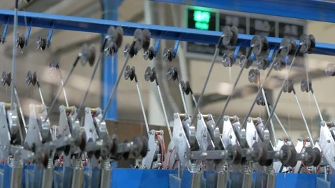 Production of copper stranded cable. Rotating shafts with fine copper thread. Stock Footage 124077242