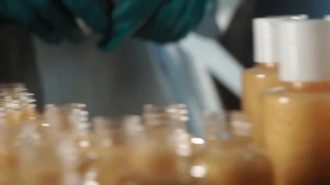Production of cosmetics. Taking a bottle of shampoo and closing it up with a Stock Footage