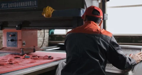 Production factory, worker controls conveyor, remote control, presses material Stock Footage 128636699