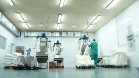 Production, factory workshop, the worker loads sugar and dry cream from bags Video stock 81070780