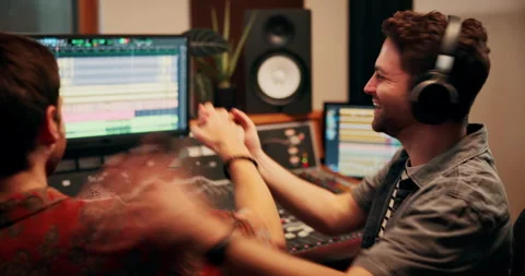 Production, high five and producers with headphones for music in studio working Stock Footage 332322222
