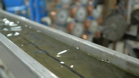 Production line of the cable. The cable in the shell is cooled in a water tank. Stock Footage 125665979