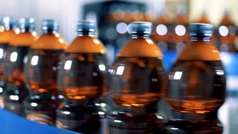 Production Line of Carbonated Drinks Close up of plastic bottle industry on a Video stock 334588702
