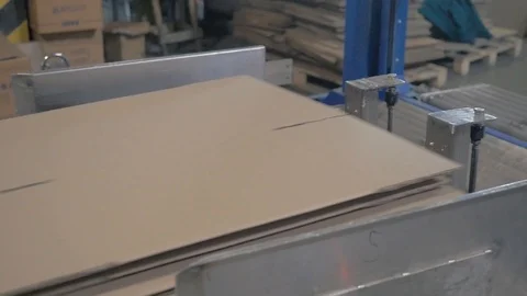 Production line forms pile with cardboard in storehouse Stock Footage 113398641