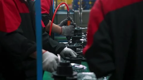Production Line Operator Uses Electric Torque Wrench for Engine Assembly Stock Footage 336771483