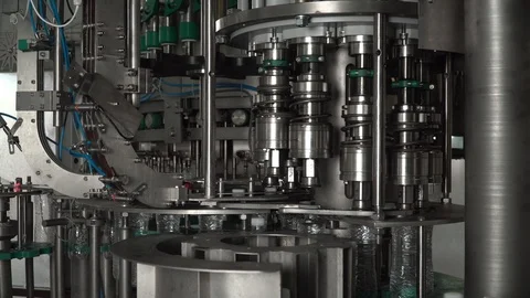 Production line of plastic bottles. Machine for filling water and twisting Stock Footage 111663496