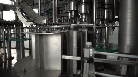 Production line of plastic bottles. Machine for filling water and twisting Stock Footage 111663533