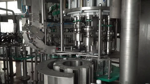 Production line of plastic bottles. Machine for filling water and twisting Stock Footage 111663598