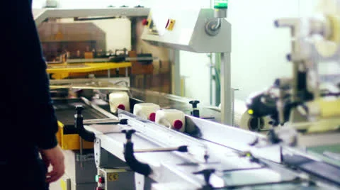 Production line with wrapping trasparent plastic film to bottles of detersive Stock Footage 22554864