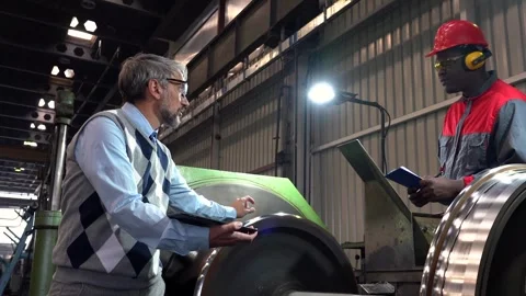 Production Manager Talking to CNC Machine Operator in a Train Factory - Zoom Out Stock Footage 283386192