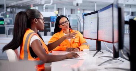 Production Managers Track Real-time Semiconductor Factory Operations On Deskt Stock Photos