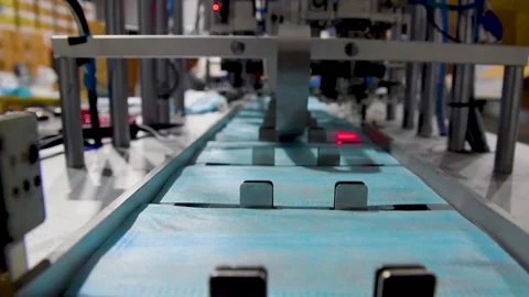 Production of medical three-layer blue or white masks. New masks move on a Stock Footage 159160628