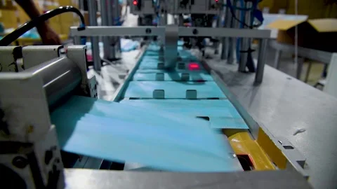 Production of medical three-layer blue or white masks. New masks move on a Stock Footage 159160704
