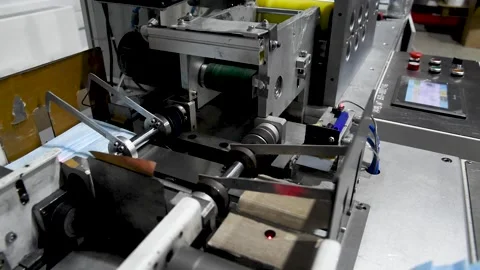 Production of medical three-layer blue or white masks. New masks move on a Stock Footage 159160981