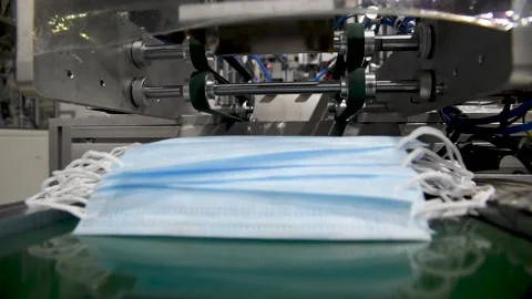 Production of medical three-layer blue or white masks. New masks move on a Stock Footage 159161054