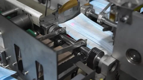 Production of medical three-layer blue or white masks. New masks move on a Stock Footage 159161200