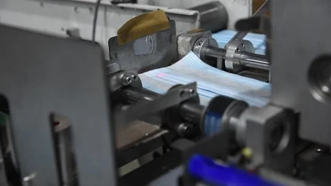 Production of medical three-layer blue or white masks. New masks move on a Stock Footage 159161290