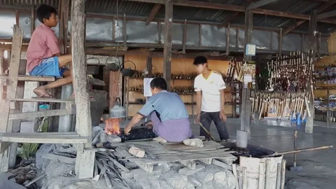 Production of metal, workshop, assistant keeps fire going, blacksmith, Inle Lake Vídeos de archivo 79838782