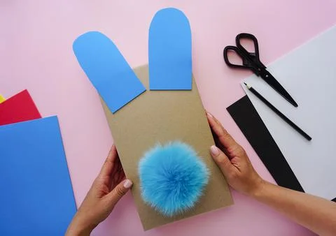 Production of packaging for a gift in the form of a hare Stock Photos