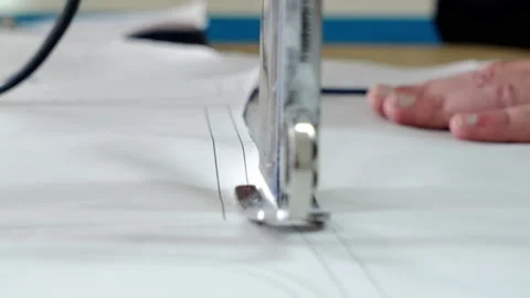 Production of patterns for clothes at a garment factory. Close up of cutting Stock Footage 199216968