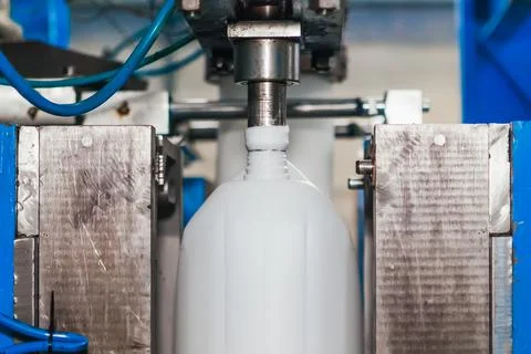 Production of plastic canisters on an automatic conveyor. Stock Photos