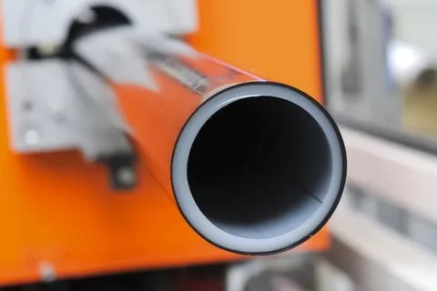 PRODUCTION OF PLASTIC DOUBLE LAYER pipe from polypropylene for water supply. Stock Photos