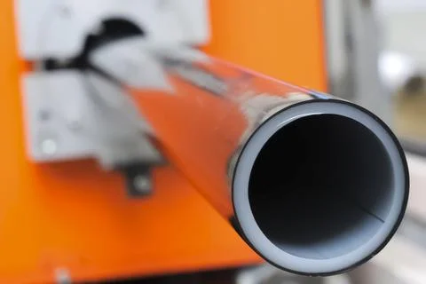 PRODUCTION OF PLASTIC DOUBLE LAYER pipe from polypropylene for water supply. Stock Photos