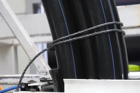 PRODUCTION OF PLASTIC DOUBLE LAYER pipe from polypropylene for water supply. Stock Photos