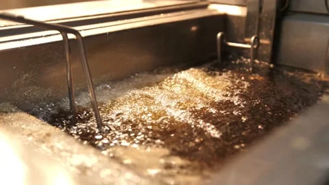 Production of potato chips and snacks. Industrial deep frying machine. Video stock 173736698